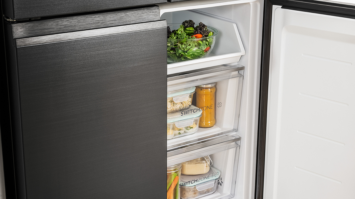 A quad door refrigerator with its lower right door opened.