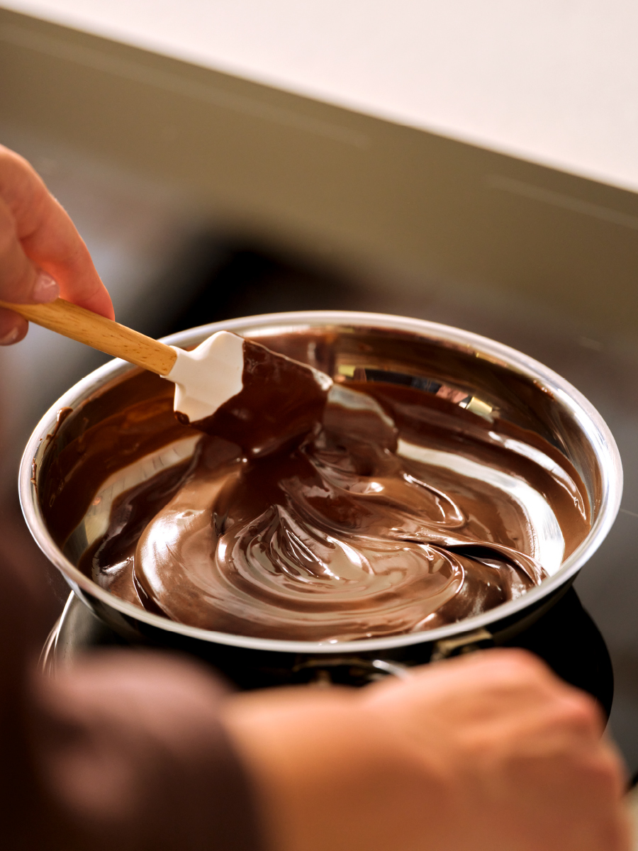 Stirring chocolate in a on a cooktop