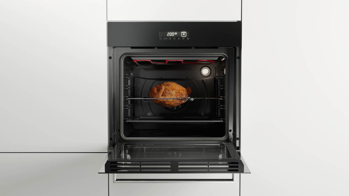 an oven with the door open showing a whole chicken being cooked
